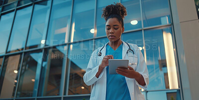 Medical, doctor and woman with tablet, outdoor and reading of information, analysis and research in clinic. Hospital, building and technology for networking, stethoscope and report for healthcare