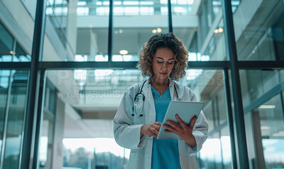 Woman, nurse and reading online on tablet for test results or review medical records and patient charts. Gastroenterologist, digital tech and internet for information on gastrointestinal condition.