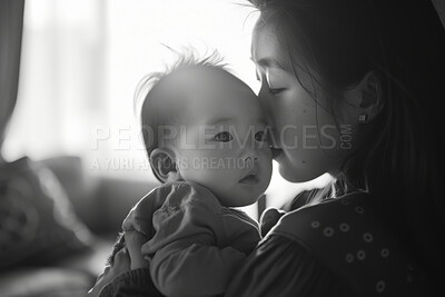 Mother, baby and face with love or care in closeup, bonding in black and white. Asian mom, child and together with nurture for newborn in family home, young with emotional or physical connection