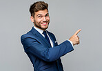 Businessman, pointing and smile by studio background for marketing, product placement and notification for sale. Portrait, happy man and space for showing info with advertising and offer on mockup