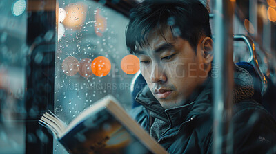 Train, book and Asian man reading, relaxing and literature with adventure, hobby and journey. Student, transport or guy with memoir, commute and weather with inspiration, raining and knowledge