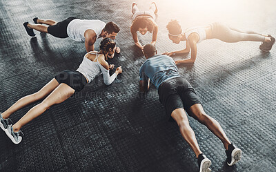 Buy stock photo Class, training and plank in group at gym for workout, core exercise or fitness together indoors. Diverse people, friends and warm up for ab muscle, session and sport for health on gymnasium floor