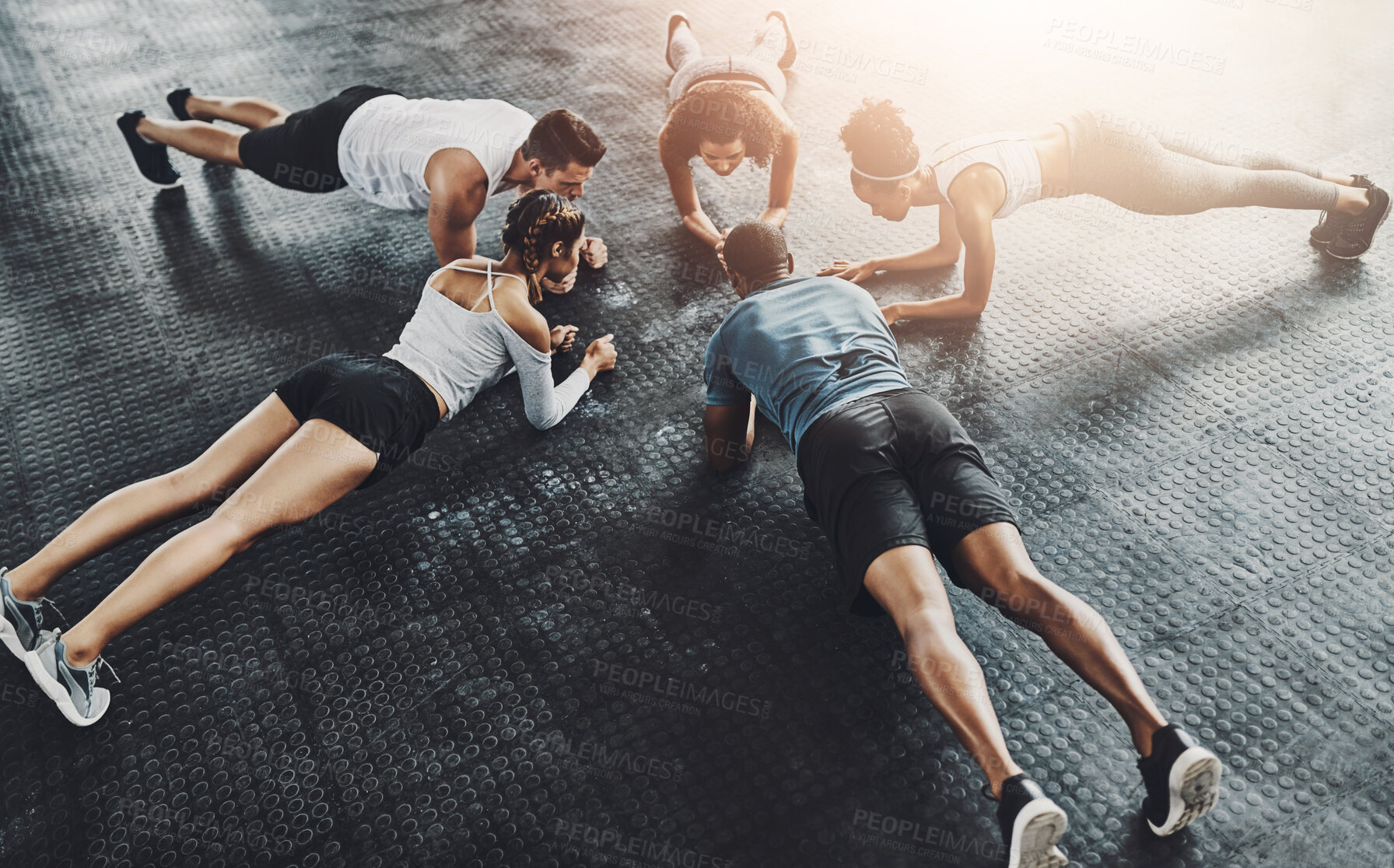 Buy stock photo Class, training and plank in group at gym for workout, core exercise or fitness together indoors. Diverse people, friends and warm up for ab muscle, session and sport for health on gymnasium floor