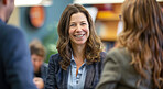 Portrait, woman and teacher in meeting, classroom and smile for colleagues and talk for curriculum. High school, education and knowledge for children, students and learners in academy and goals