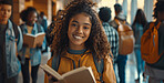 Girl, student and book in school corridor, learning institute and children or walking for education class. Child, backpack and confident with study textbook, happy and smile for development or growth