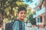 Education, children and portrait with boy learner outdoor on street for learning at school. Backpack, face and student with smile of young kid as pupil at academy for child development or scholarship