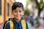 School, children and portrait with student boy outdoor on street for education or learning. Backpack, face and scholarship with happy young kid as learner or pupil at academy for child development