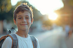 Children, education and portrait with student boy outdoor on street at school for learning. Backpack, face and scholarship with smile of young kid as learner or pupil at academy for child development