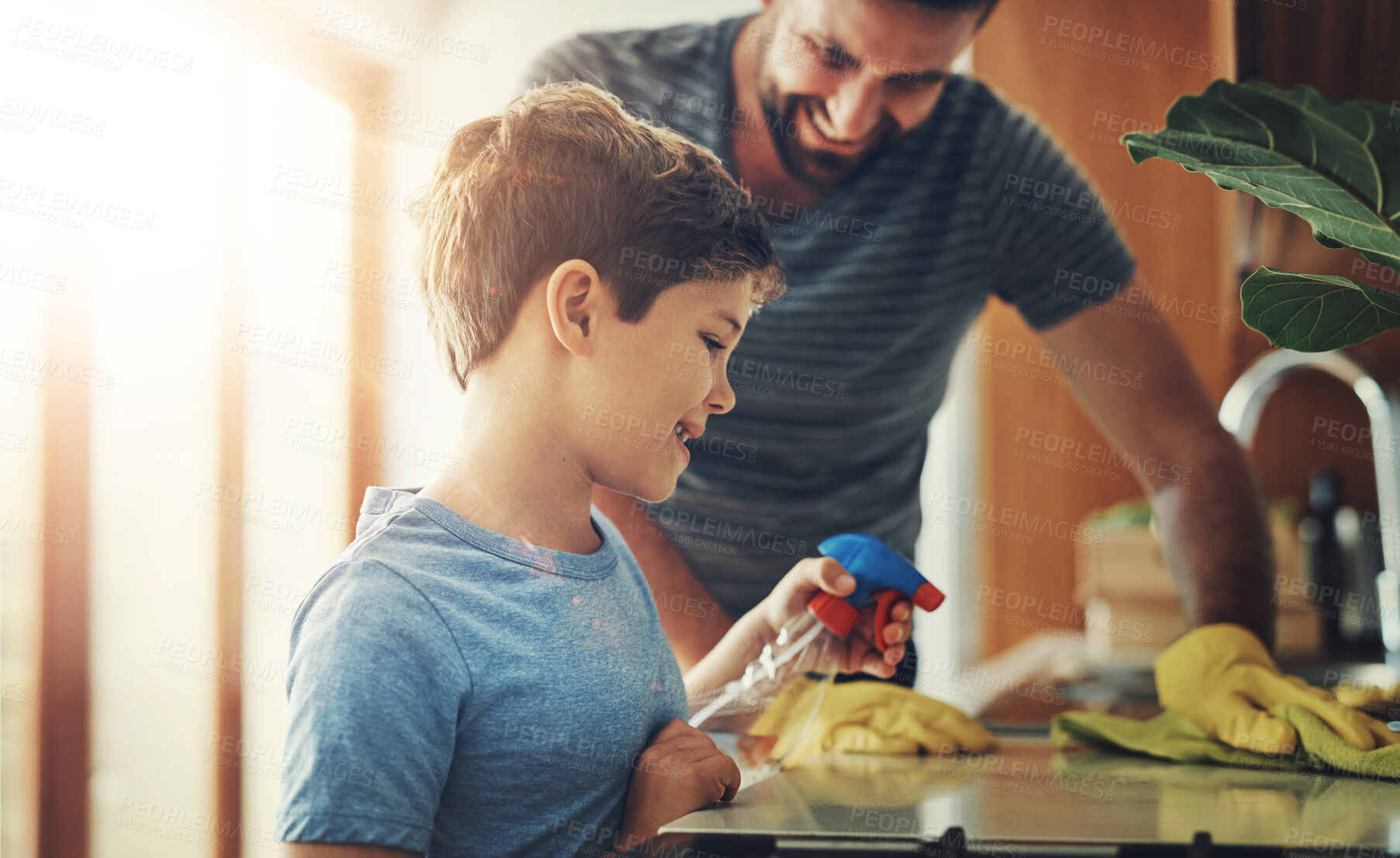 Buy stock photo Child development, cleaning or hygiene with father and son in kitchen of home for household chores together. Learning, spray bottle and table with man teaching boy about bacteria in apartment