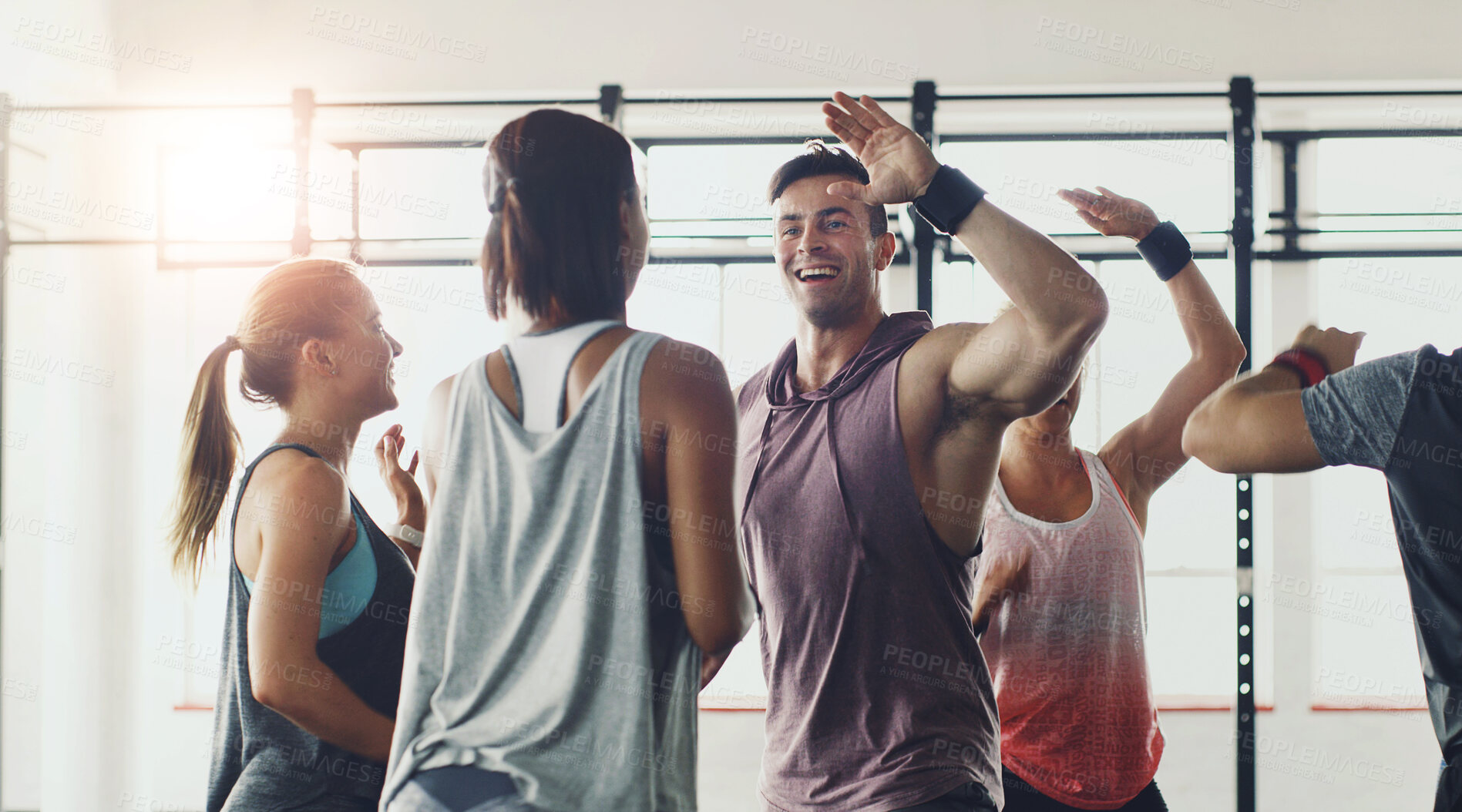 Buy stock photo Fitness, high five or motivation and coach with students in gym for congratulations or support. Goals, success or target and personal trainer in celebration with class of people for exercise routine