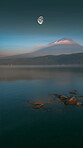 Lake, mountain and moon in nature of landscape, evening and Switzerland for travel, adventure and journey. Outdoor, tourism and hill for rock climbing, hike and trekking for vacation, trip or holiday