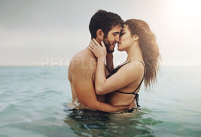 Buy stock photo Love, water and couple at beach with kiss on vacation, adventure and holiday for valentines day. Intimate, hug or man with embrace for bonding together and woman by ocean for romantic trip on island