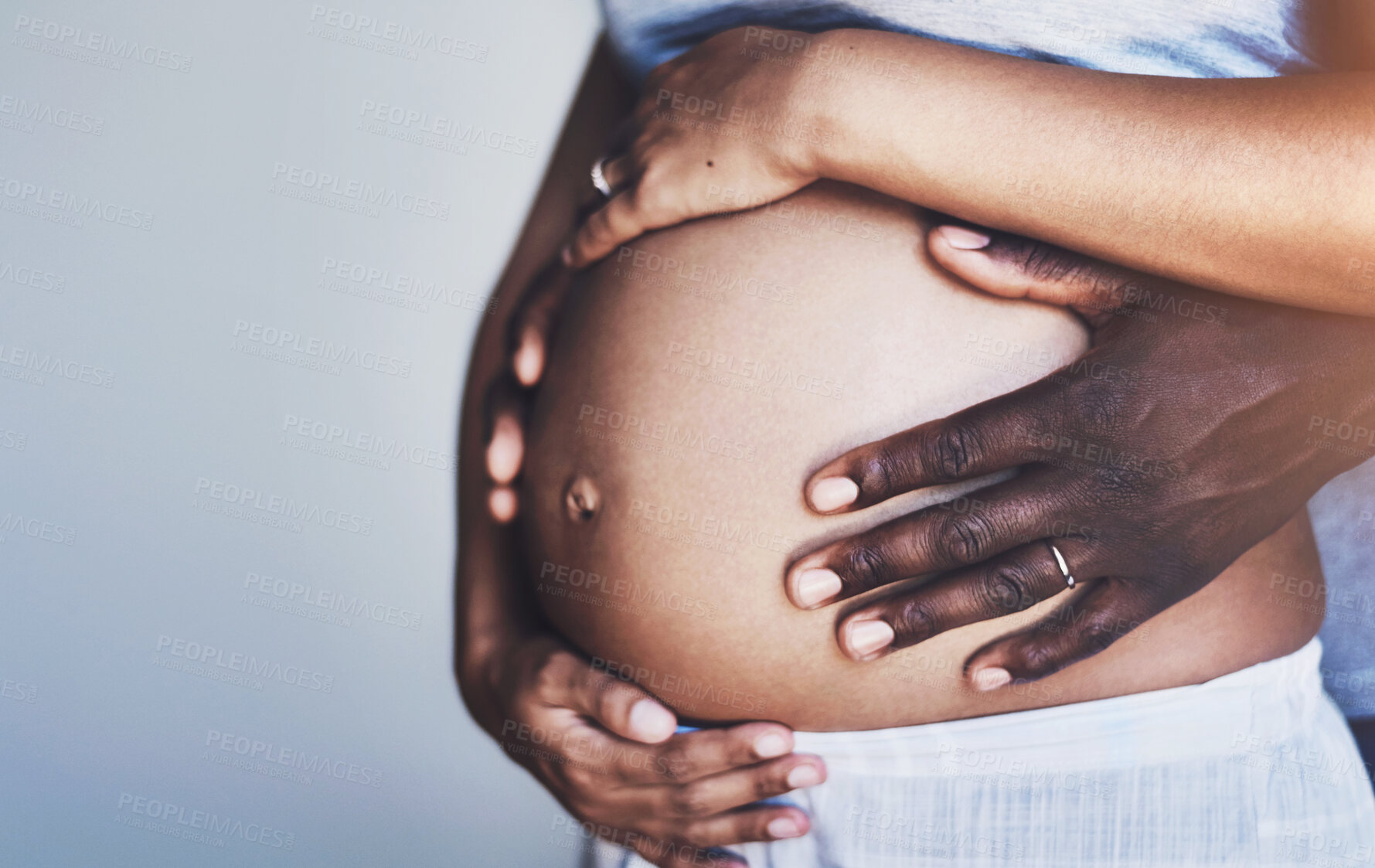 Buy stock photo Couple, hands and pregnant belly in home for love, bonding and tummy touch for affection or care. People, stomach and hug for maternity announcement, together and commitment or support to future