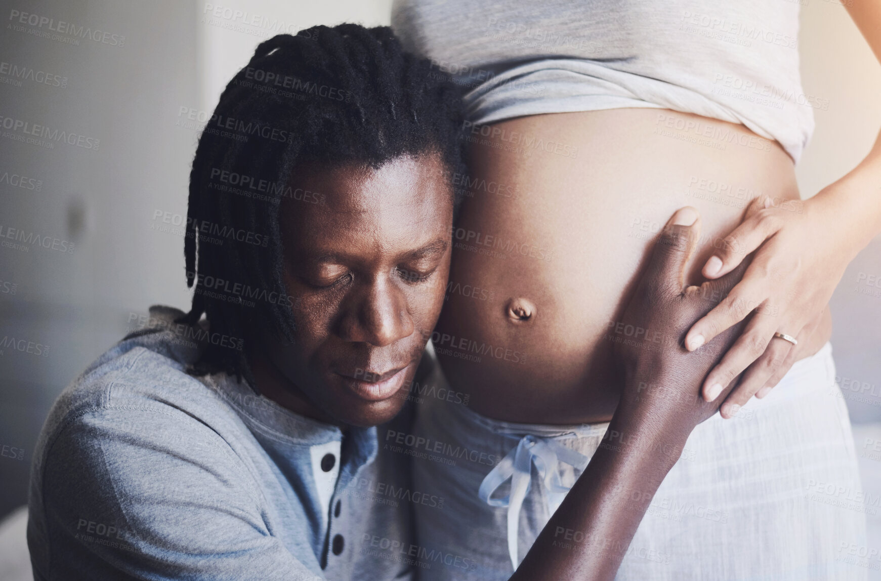 Buy stock photo Couple, home and listen to pregnant stomach for heartbeat sound, support and bonding together in bedroom. Woman, man and pregnancy belly for hearing baby, love relationship and care for future family