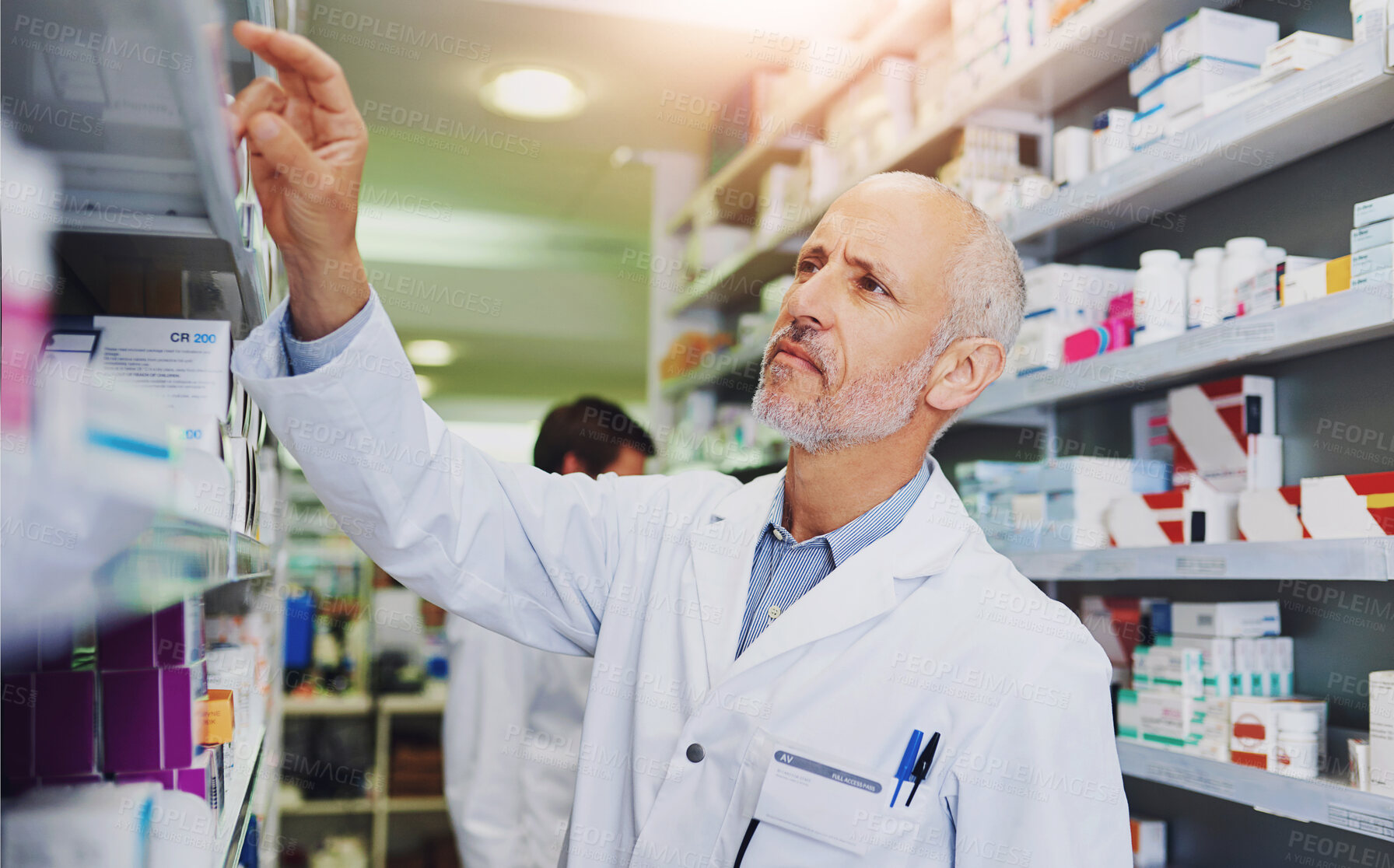 Buy stock photo Pharmacist, medicine and stock in clinic for healthcare, wellness and service for retail. Man, doctor and inventory for pills or supplements in hospital for inspection, information and check label