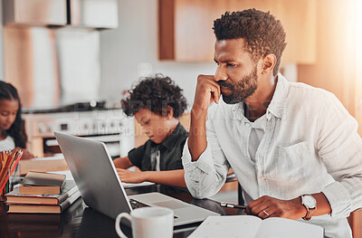 Buy stock photo Shot of a man using his laptop while sitting with his children