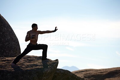 Buy stock photo Fitness, karate and man on mountain top for body training, power or defense practice on blue sky background. Martial arts, MMA and guy taekwondo master in nature for exercise, sport or morning mockup