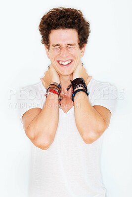 Buy stock photo Smile, fashion and an edgy young male model in studio isolated on white background for rocker style. Accessories, eyes closed and a funky punk man in a casual clothes outfit for individual expression