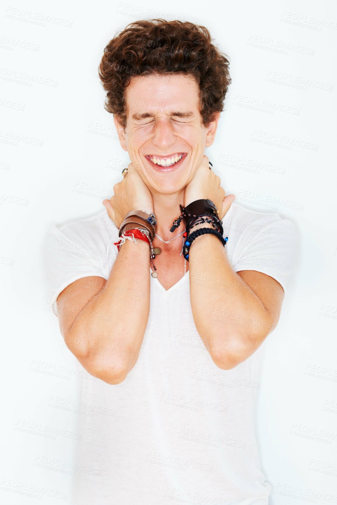 Buy stock photo Smile, fashion and an edgy young male model in studio isolated on white background for rocker style. Accessories, eyes closed and a funky punk man in a casual clothes outfit for individual expression