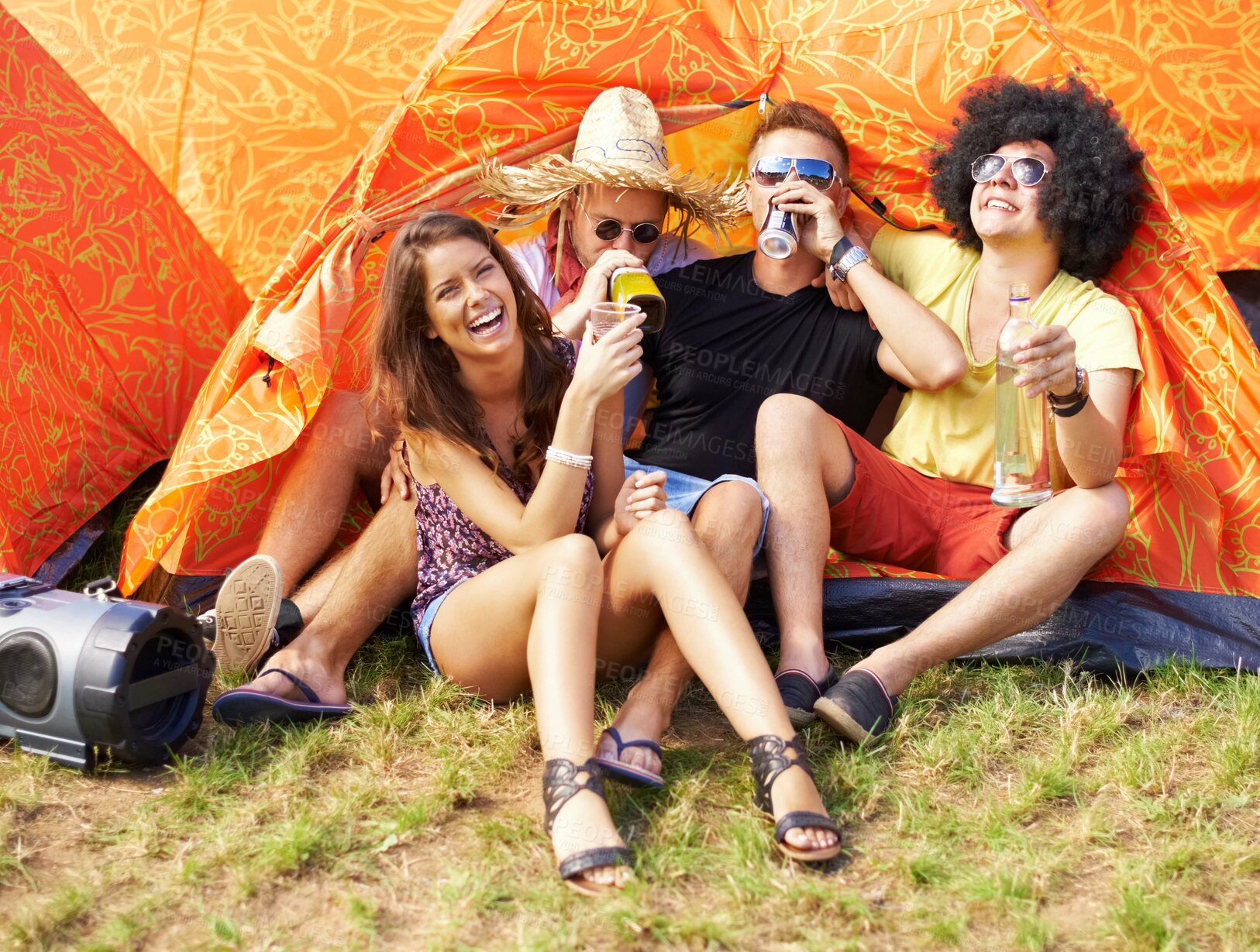 Buy stock photo Friends, music festival and drink alcohol by tent, excited and relax wellness in nature with bonding. Men, woman or laugh at celebration for concert, weekend vacation or care in summer fun in woods