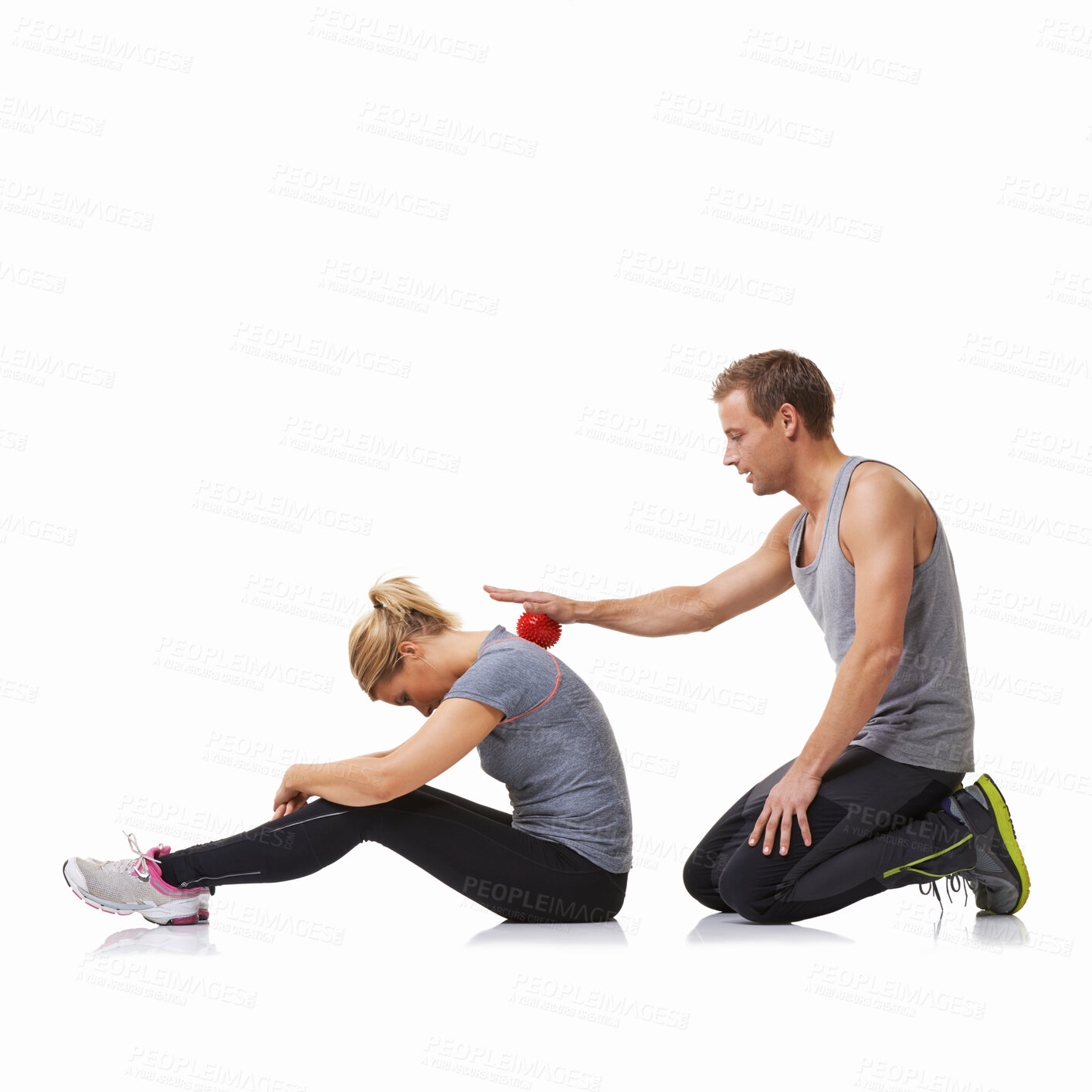 Buy stock photo A young man using a massage ball on his female friend's back