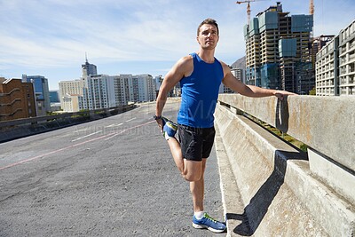Buy stock photo Man, stretching legs and running in city, warm up for cardio workout and fitness outdoor. Athlete, sports and runner in New York with health, wellness and ready for race or marathon on urban bridge