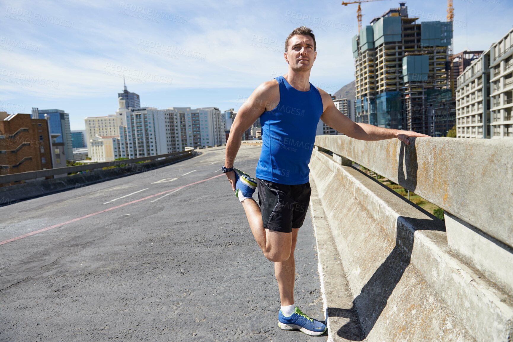 Buy stock photo Man, stretching legs and running in city, warm up for cardio workout and fitness outdoor. Athlete, sports and runner in New York with health, wellness and ready for race or marathon on urban bridge