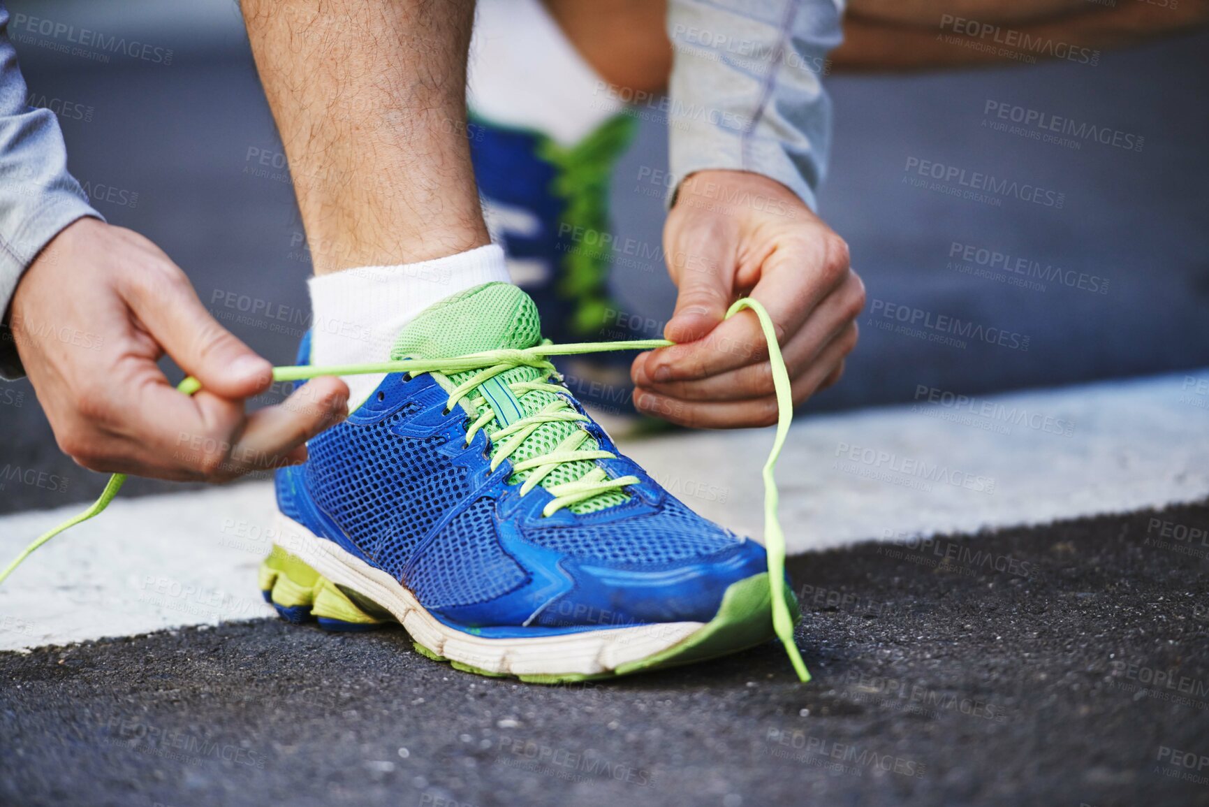 Buy stock photo Foot, runner and tying laces on street in outdoors, cardio and exercise or training for marathon. Person, athlete and ready for workout in closeup, sportswear and performance challenge on asphalt
