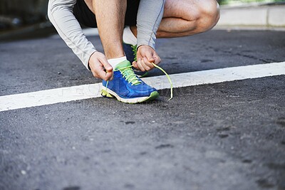 Buy stock photo Foot, runner and tying laces on road in outdoors, cardio and exercise or training for marathon. Person, athlete and ready for workout in closeup, sportswear and performance challenge on asphalt