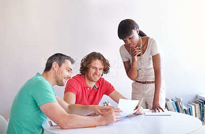 Buy stock photo Teamwork, colleagues brainstorming and at desk in a modern workplace office together for support. Collaboration or diversity, ideas or strategy and group of people planning at workstation for goal