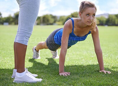 Buy stock photo Women, coach and push ups on grass for fitness with exercise, training and workout on sports field. Athlete, person and confidence on ground and physical activity for healthy body, wellness and core