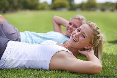 Buy stock photo Happy woman, portrait and friends in sit ups for outdoor exercise, workout or fitness together on green grass. Young active female person or people smile for training or health and wellness on field