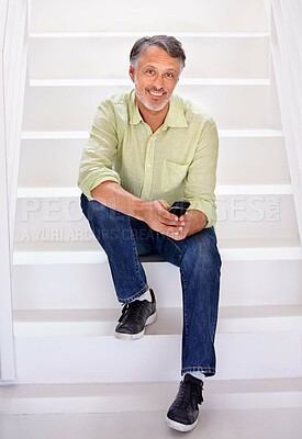 Buy stock photo Man, portrait or phone on stairs in office for social network, download digital app or business contact in agency. Happy mature entrepreneur typing on smartphone, mobile notification or chat on steps
