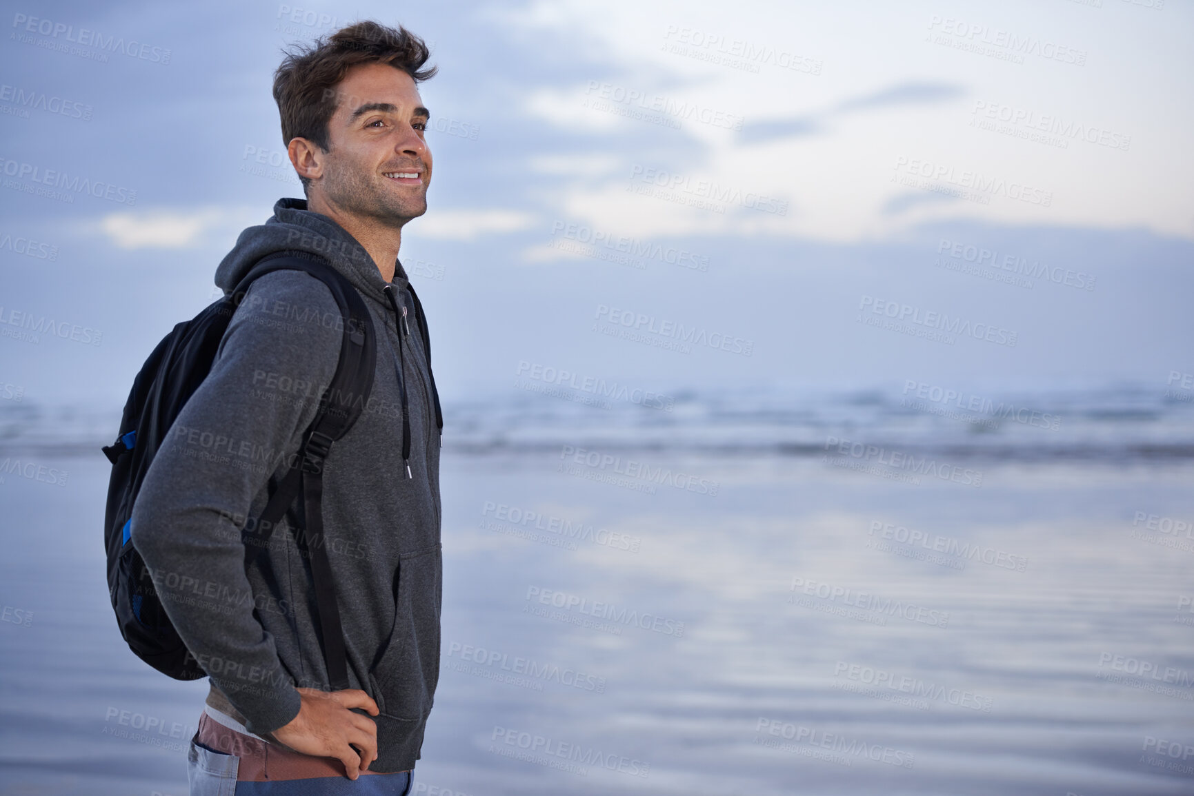 Buy stock photo Thinking, beach and man with vacation, travel and backpack with happiness, smile or getaway trip. Person, seaside or traveller with nature or wellness with water, explore or holiday with summer break