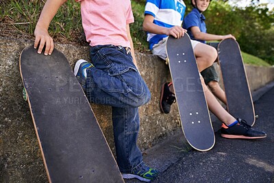 Buy stock photo Kids, friends and skateboard for outdoor sports together or exercise sneakers for workout, balance or city street. People, legs and neighbourhood fitness on road for transport, practice or relaxing