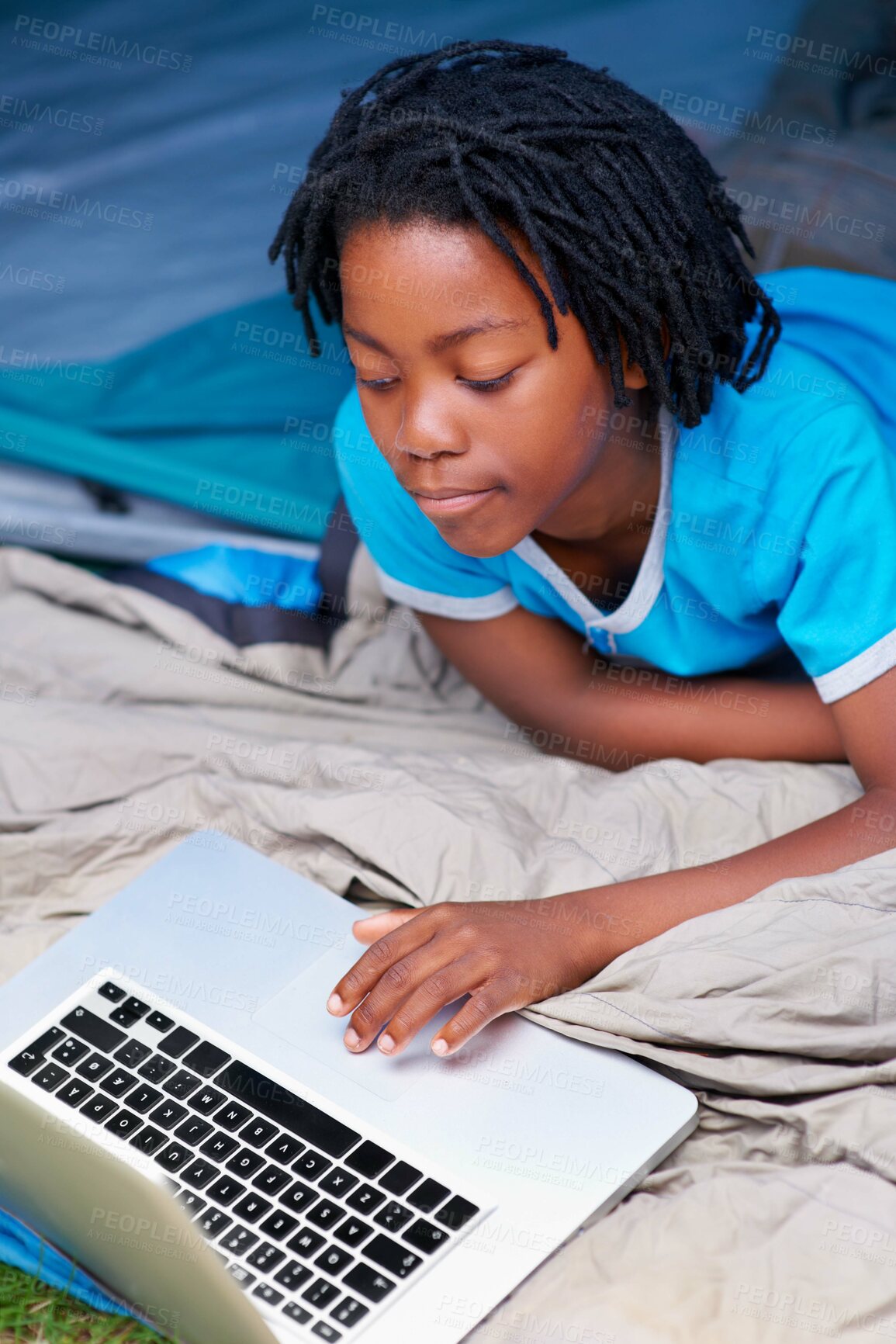 Buy stock photo Child, relax and play with laptop in tent with cartoon, movie or online games on holiday or vacation. Kid, smile and watch video on streaming, website or search on internet for computer elearning