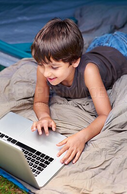 Buy stock photo Kid, relax and laptop to watch cartoon, movie or online games for holiday or vacation. Child, smile and play video with computer on website, streaming or search on internet for elearning with media