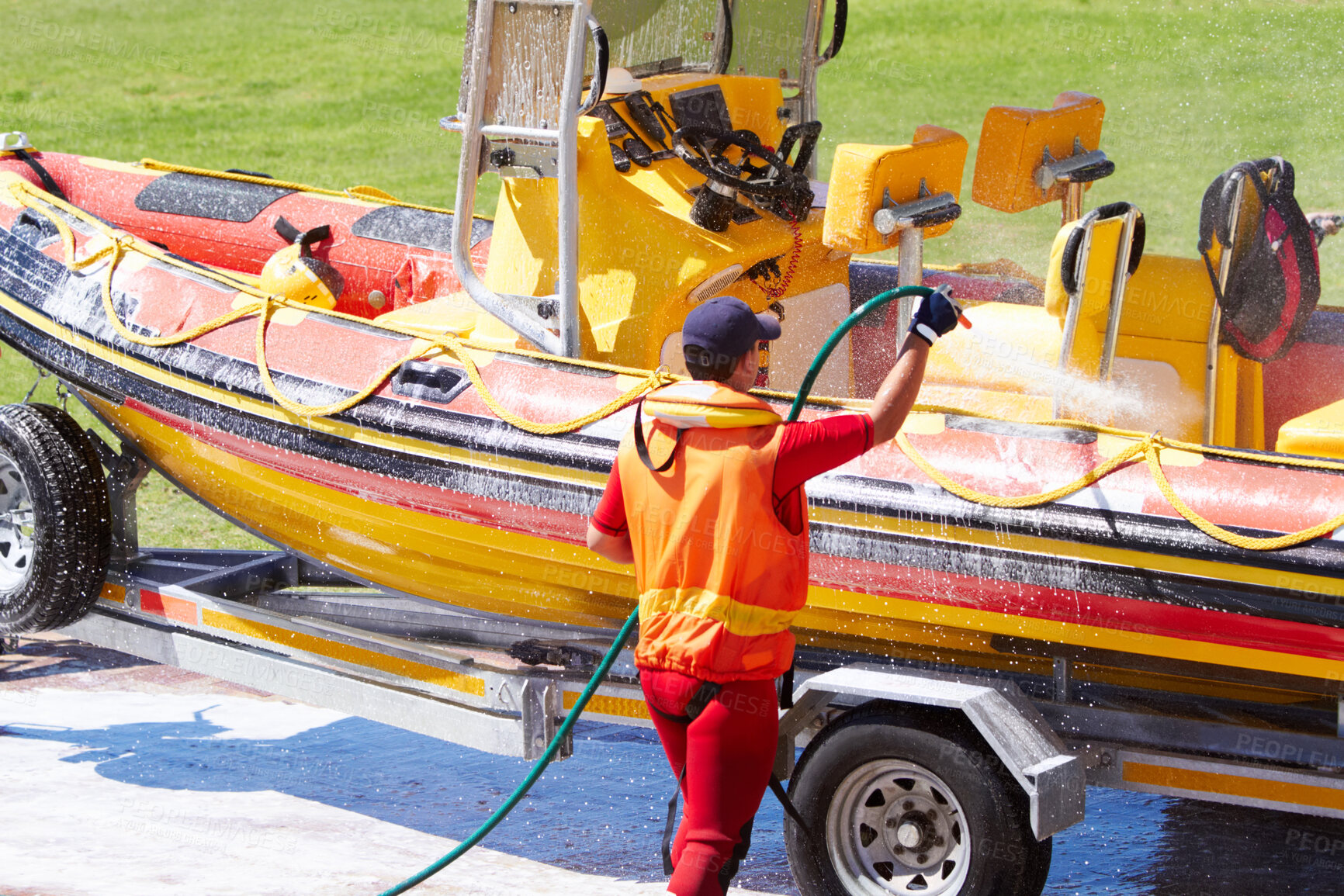 Buy stock photo Cleaning, boat and rescue or emergency worker washing speedboat ready for search mission for an investigation. Safety, person or man coast guard employee in preparation for water service