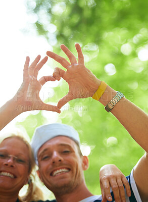 Buy stock photo Portrait, festival and couple with heart sign, love and happiness with romance gesture and celebration. Face, people and outdoor with man and woman with symbol for love and marriage with joy