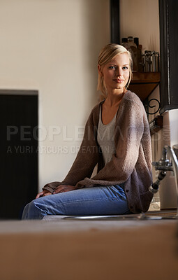 Buy stock photo Portrait, young woman and sitting at home, looking out the window relaxing. Face, smile and happy calm female person, chilling and peaceful on her kitchen counter in a house while positive on weekend