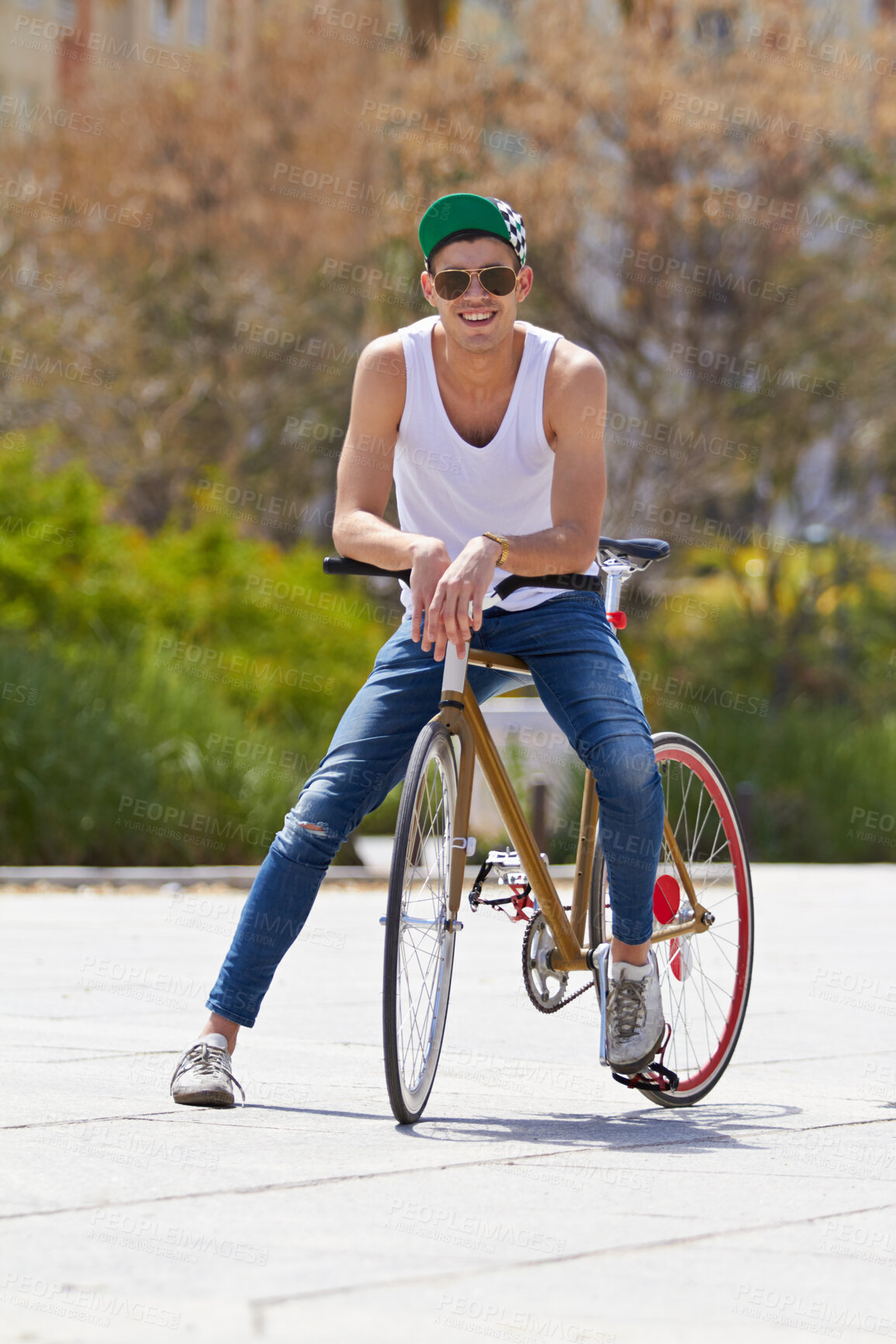 Buy stock photo A handsome young man riding his bicycle outdoors