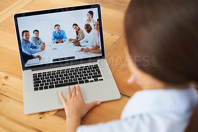 Buy stock photo Rear view of a young businesswoman in a video conference with her colleagues