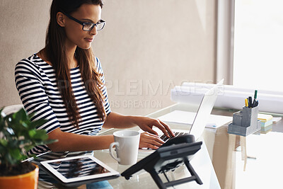 Buy stock photo Woman, desk and computer with blueprints for interior design or creative career, happy and working on graphics on laptop. Online, search and plan project with digital technology and information