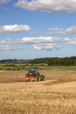 Buy stock photo Field, grass and tractor for farming rice, agriculture and sustainability in countryside or environment. Farmer plough for wheat, plants and harvesting on land for production, supply chain and nature