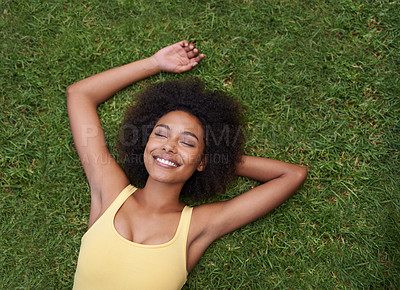 Buy stock photo Sleeping, grass and mockup with a black woman lying on a field from above for peace or quiet outdoor in nature. Dream, relax and zen with an attractive young female resting alone in the countryside