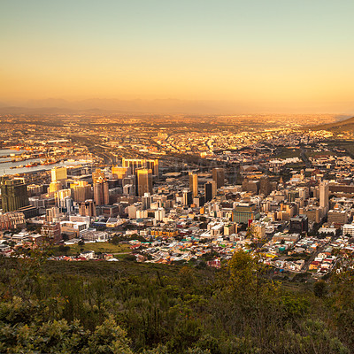 Buy stock photo Sky, city and sunset with building infrastructure under the horizon of a coastal town surrounded by nature. Business, travel or corporate buildings with a view of an urban skyline landscape in summer