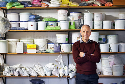 Buy stock photo Shot of a store owner standing in front of his merchandise