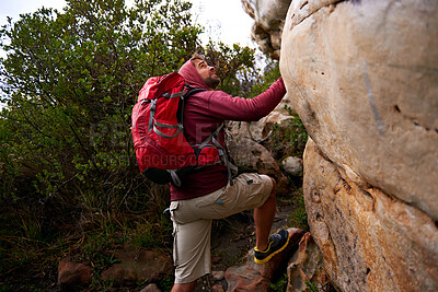 Buy stock photo Rock climbing, hiking and man on mountain, nature and environment for outdoor adventure. Male person, athlete or sport in environment for exercise, fitness or health with backpack by plants in forest