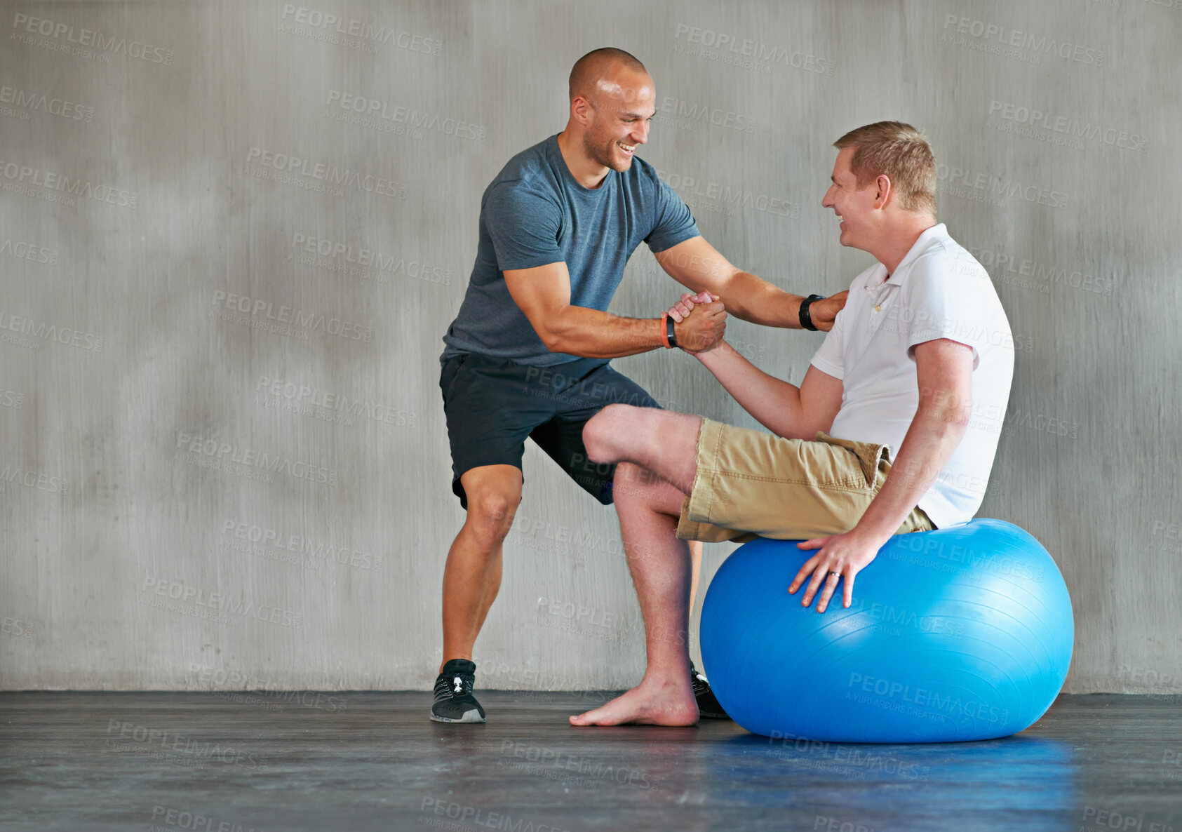 Buy stock photo Physical therapy, amputee and exercise ball with a man with a disability and physio for rehabilitation. Physiotherapy, help and healthcare professional with trainer helping and wellness for mobility