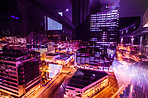 Buildings, city lights and dark urban background of road, street and building at night. Cityscape architecture, skyscraper and skyline outdoor with buildings and city street neon lighting backgrounds